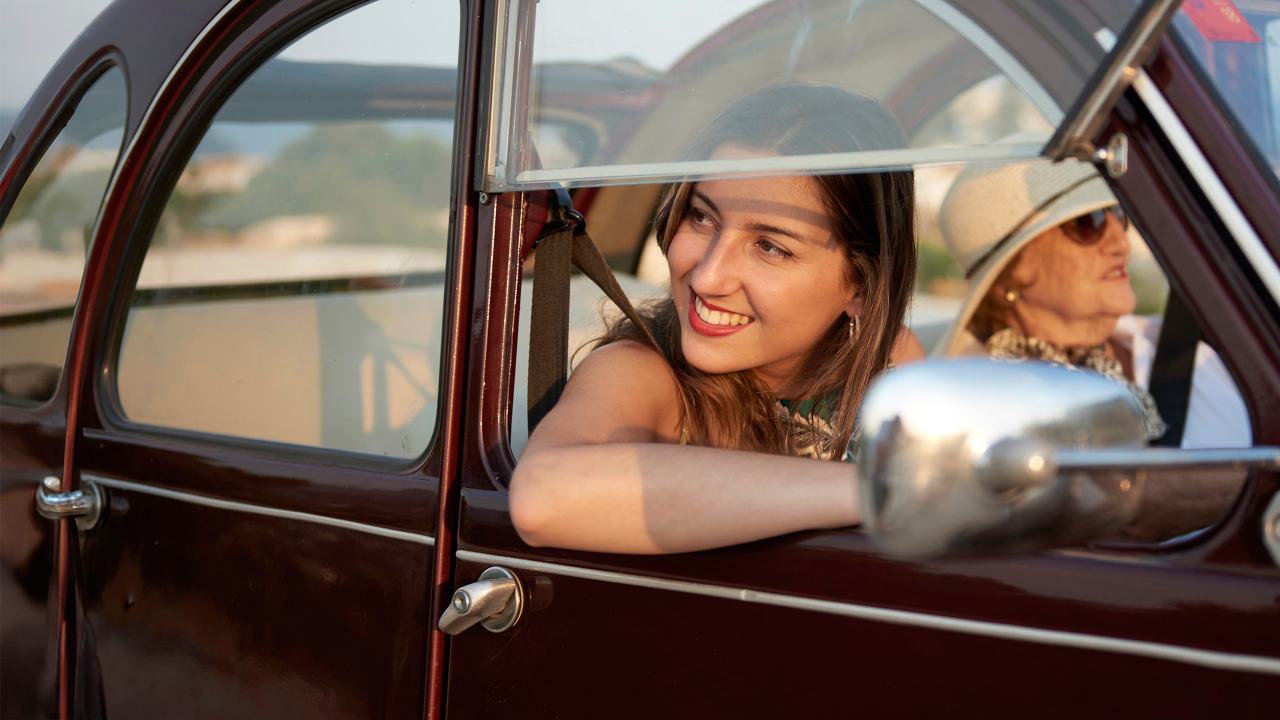 Modern grandmother on a road trip with two granddaughter