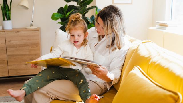 mum and young daughter reading